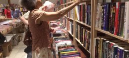 Shoppers browse through six rooms of The Newberry on Thursday during the 32nd annual book fair.